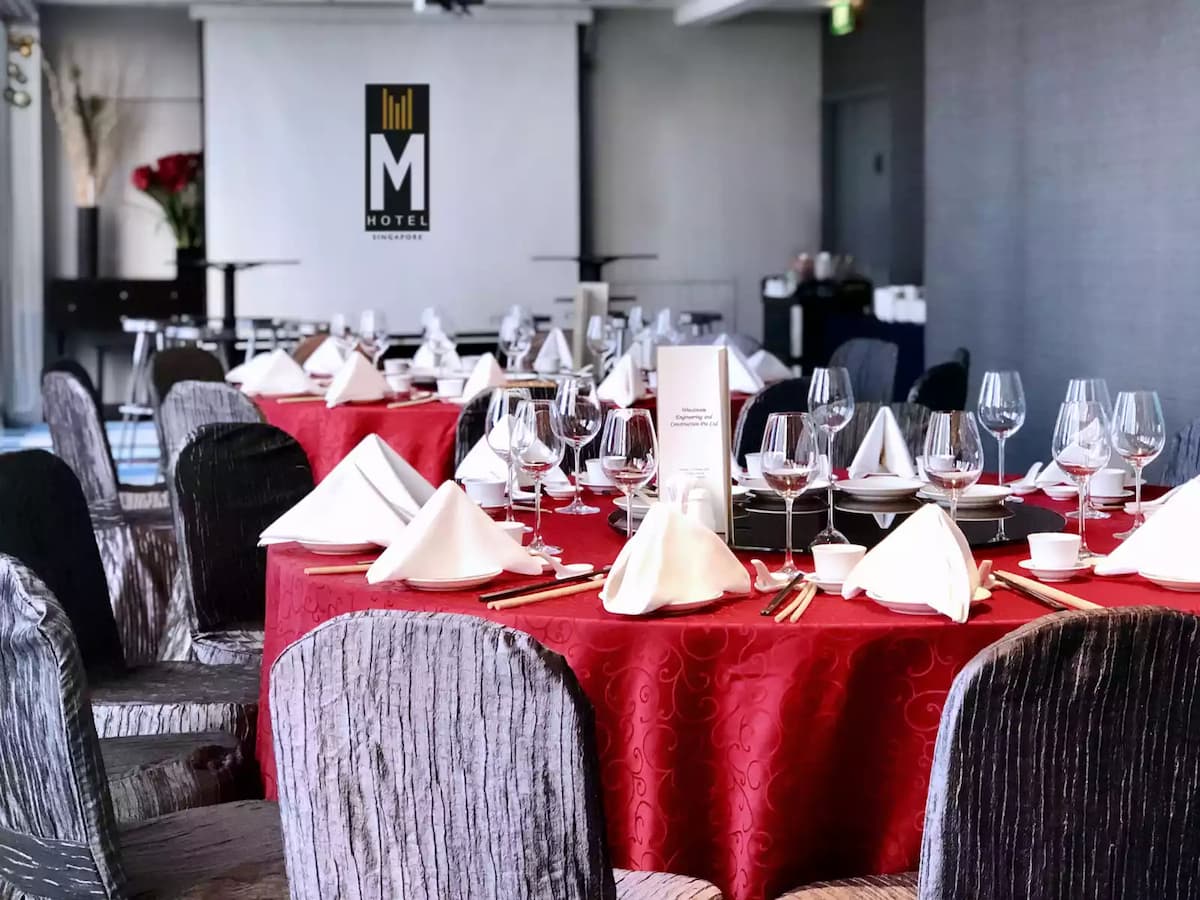 red draped round tables in banquet room
