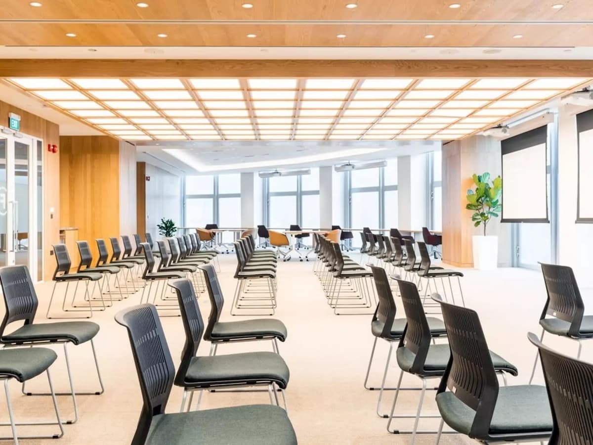 spacious seminar venue with office chairs facing projector screens