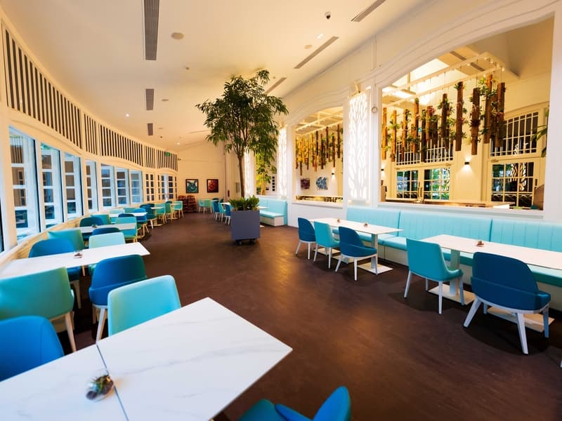 large room with light blue and dark blue chairs