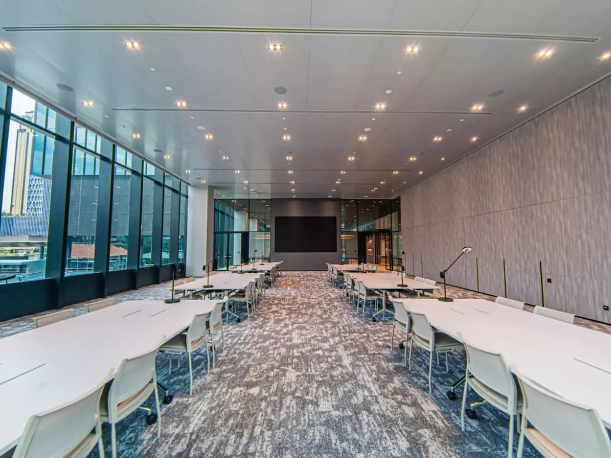room with tables and chairs setup for meeting or panel