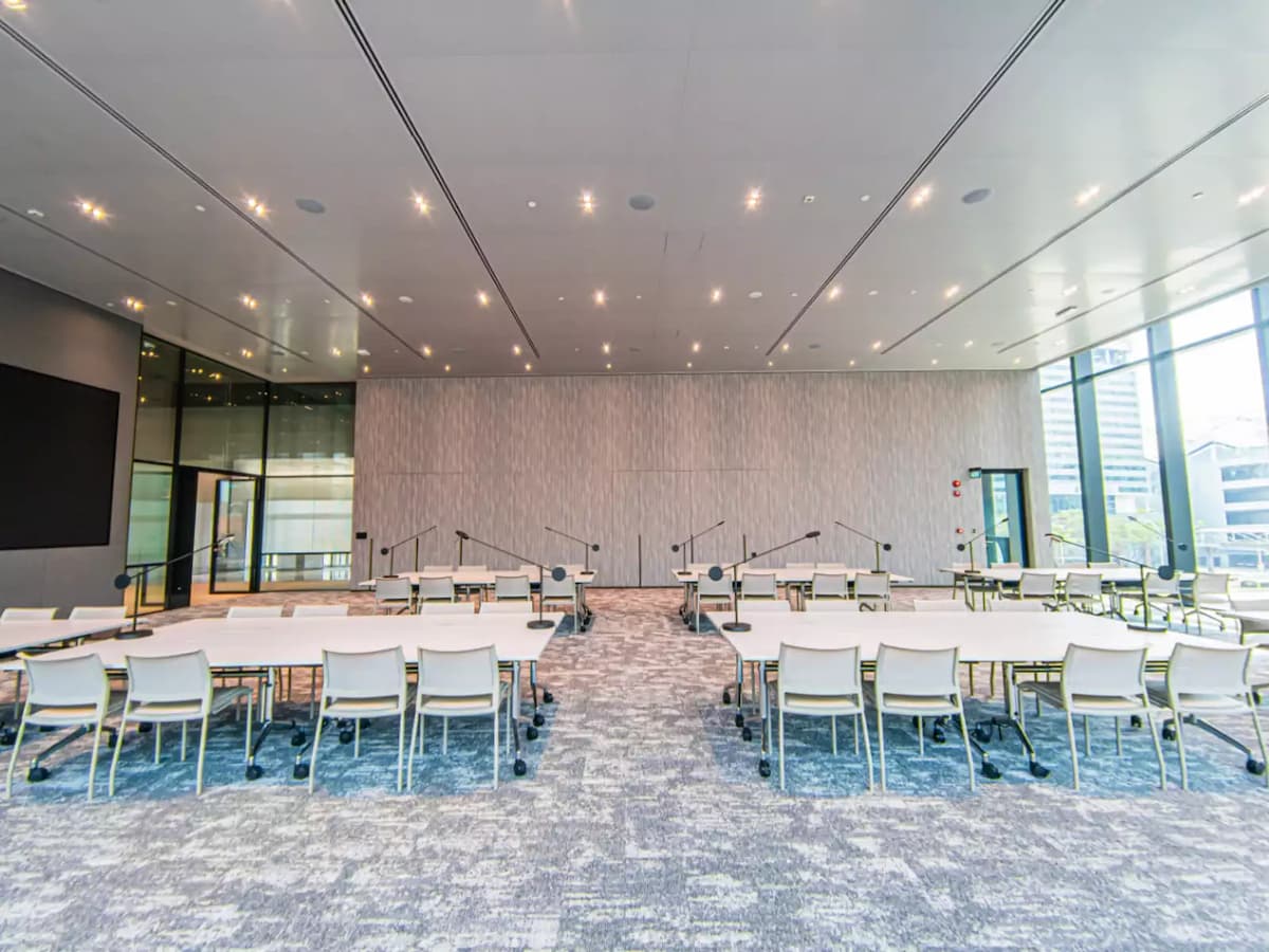 spacious room with chairs and mic stands in front