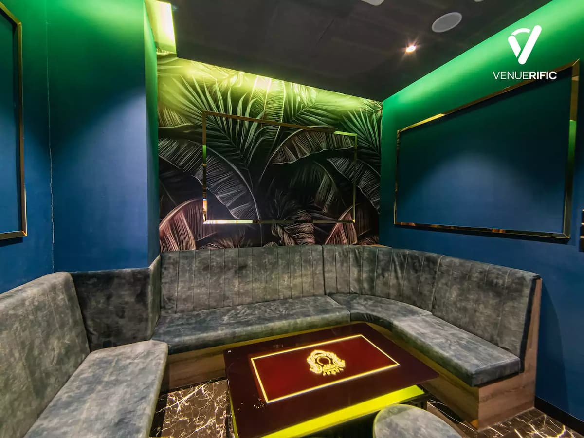 small ktv room with blue and green gradient wall and leaves wall design