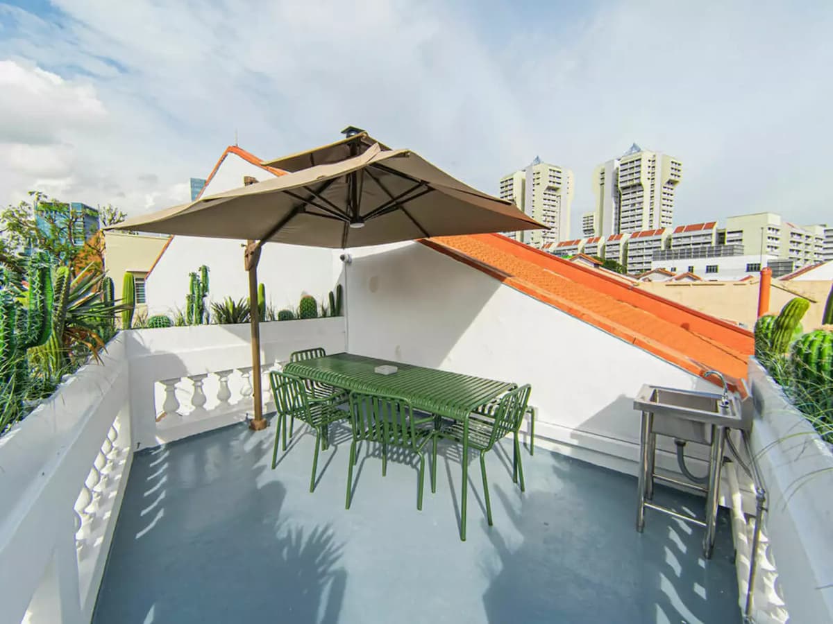 bright rooftop dining area with view of the city