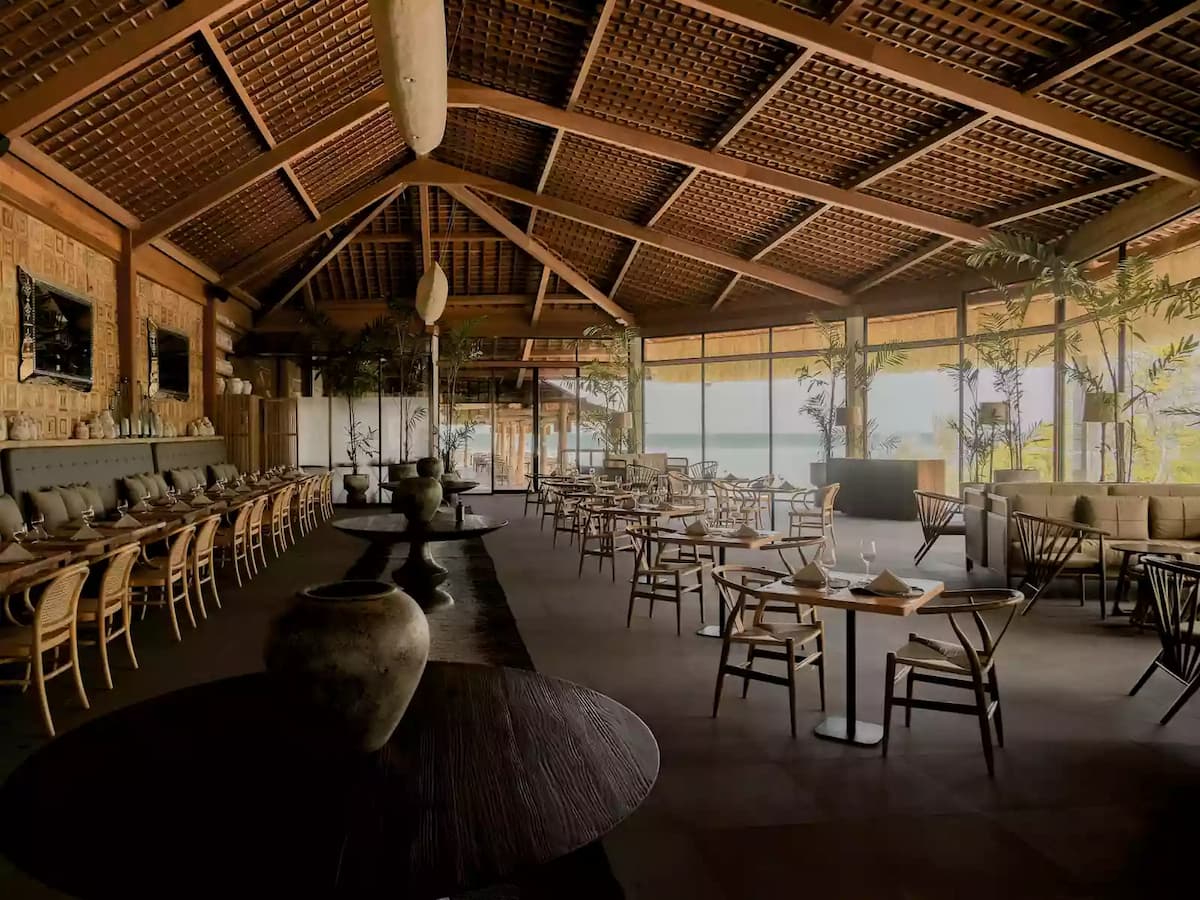 spacious dining space with rattan and wooden decoration