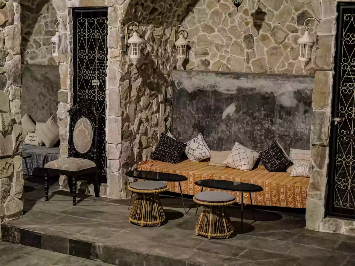 rustic lounge with stone walls, wrought iron doors