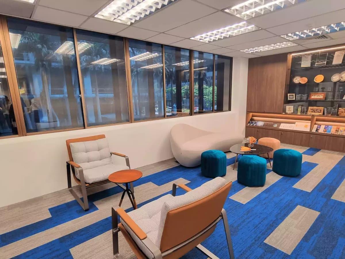 cozy lounge area with various seating on a carpet