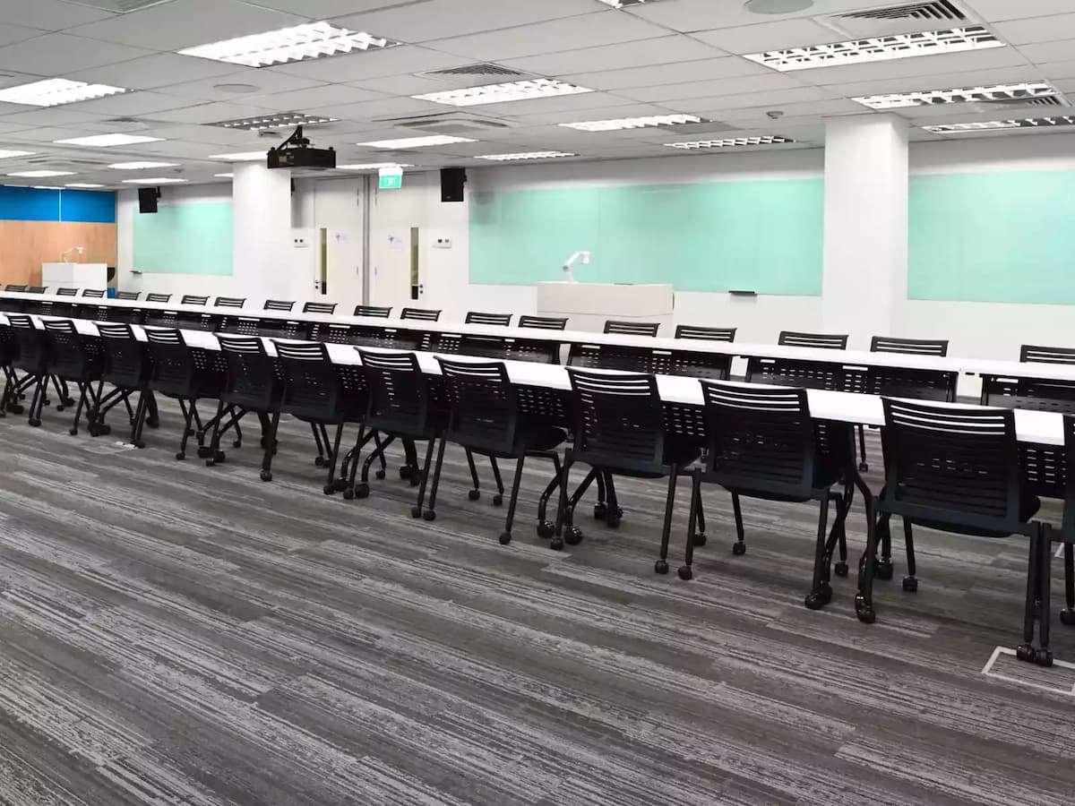 long tables and rows of chairs in boardroom set up
