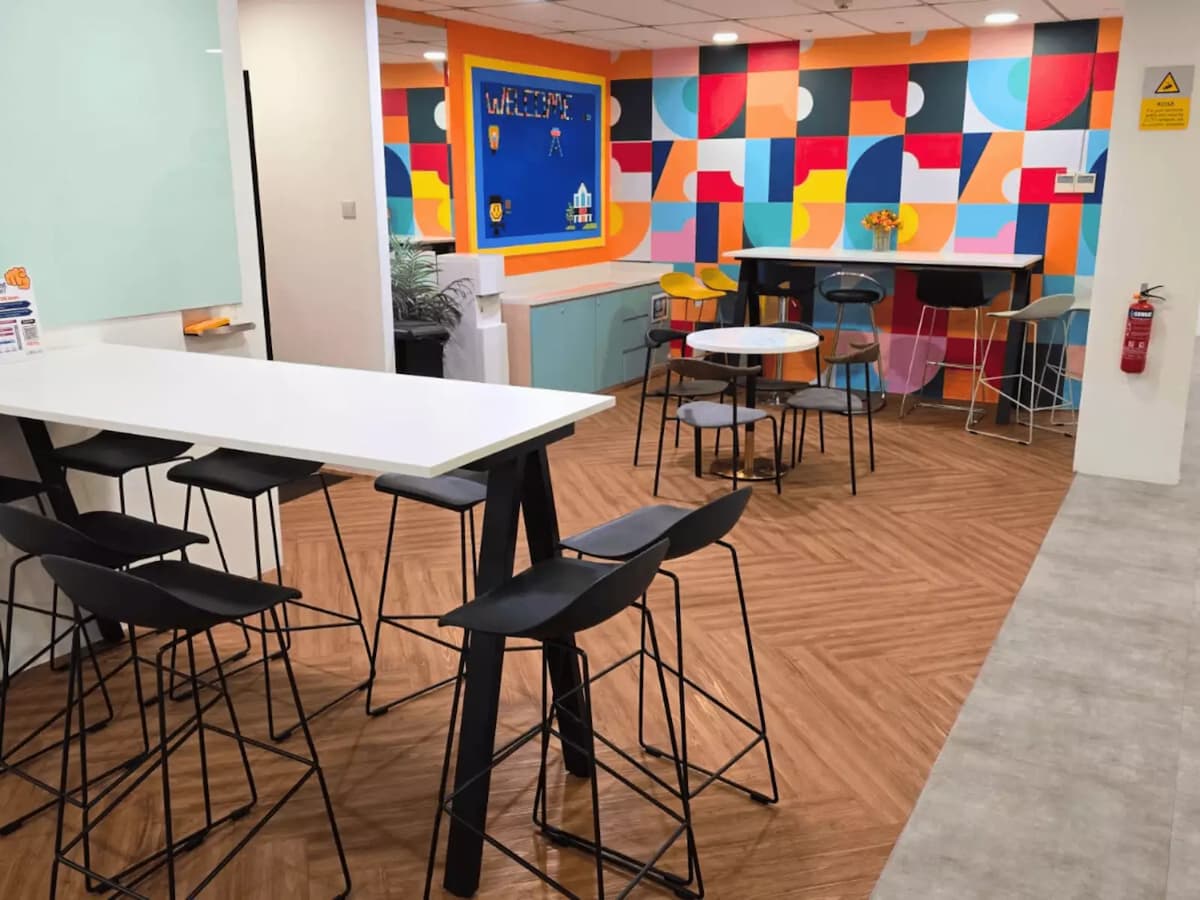 minimalist area with colorful wall and various seating