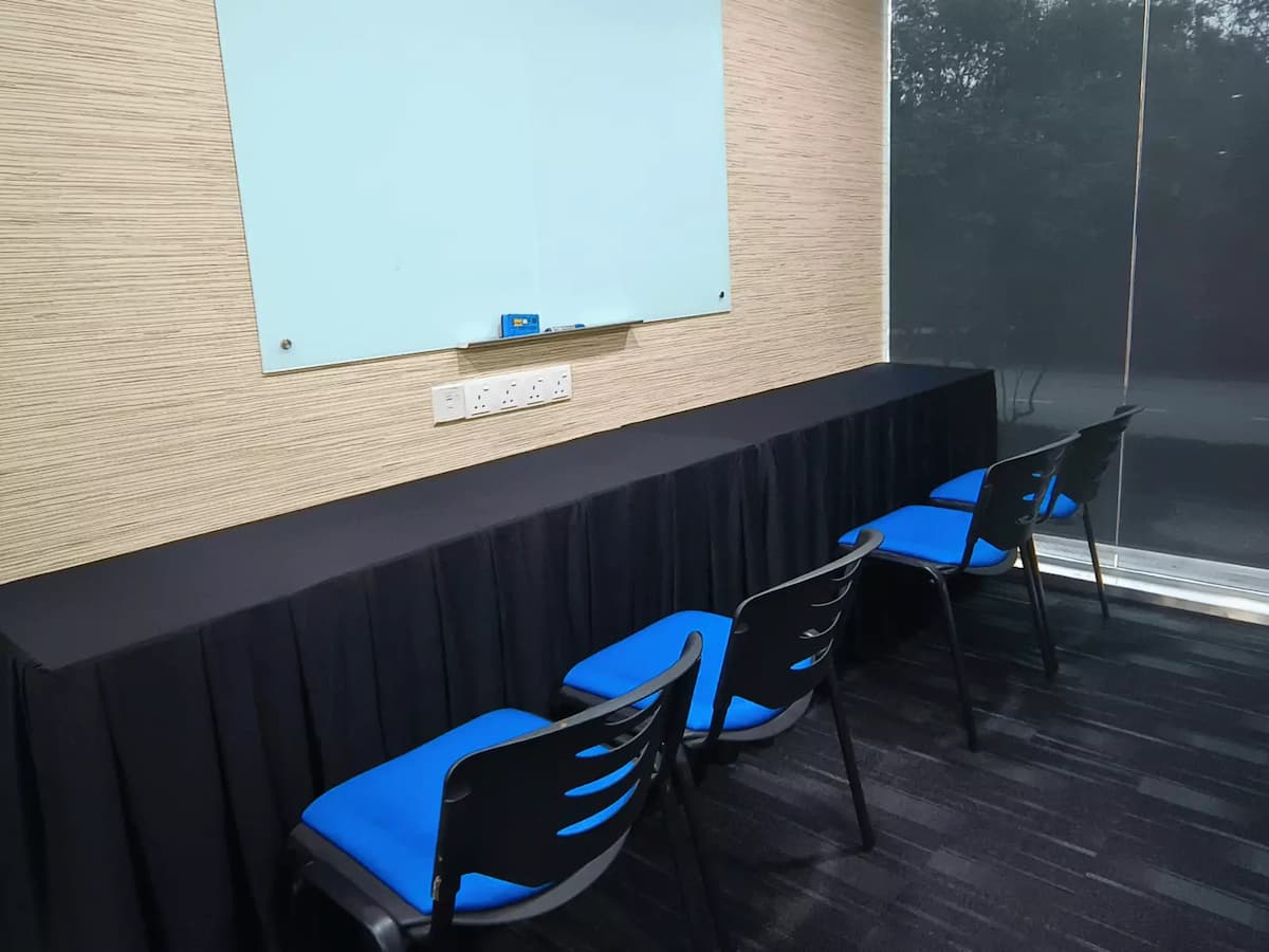 long table with chairs facing a whiteboard