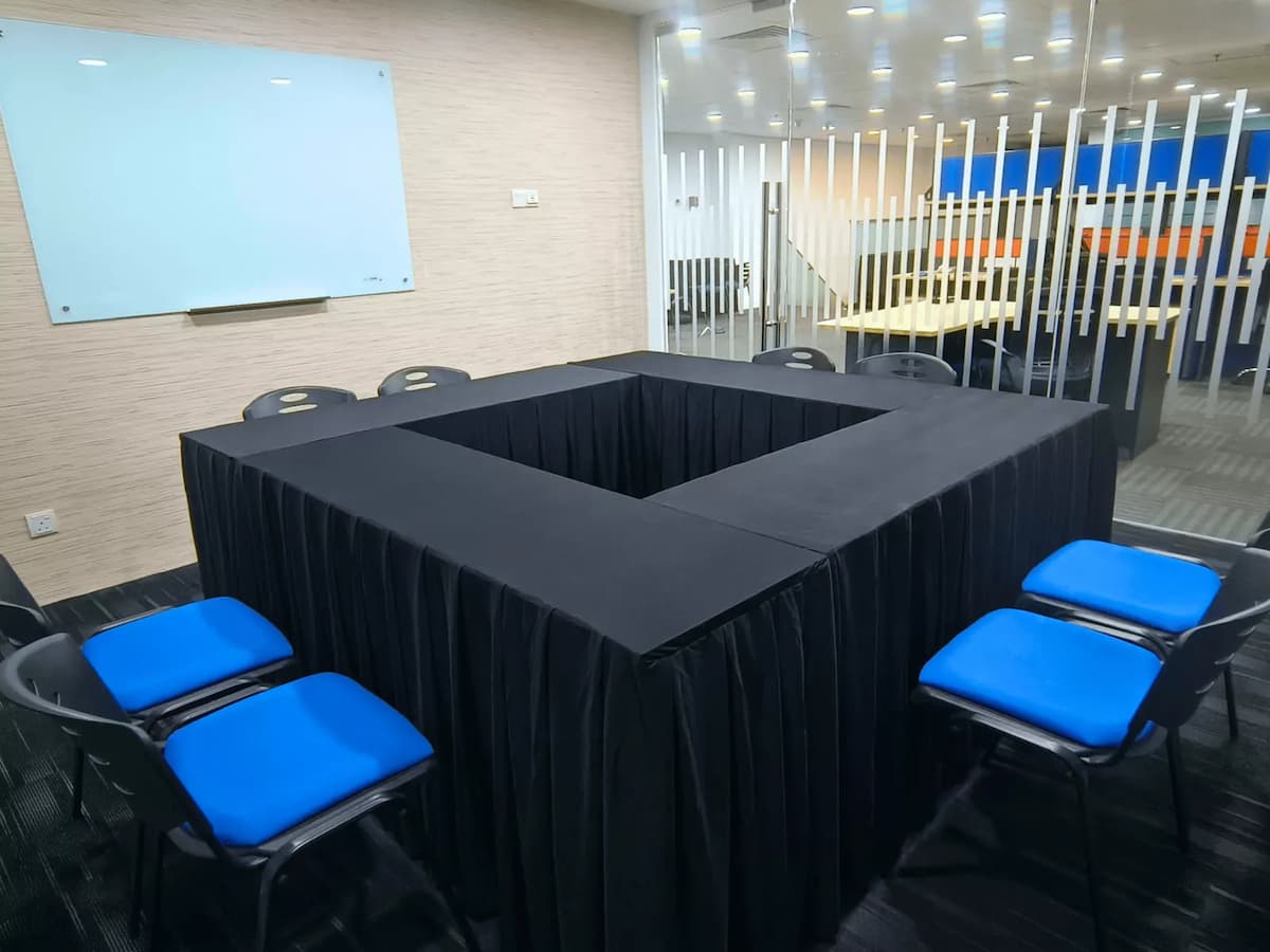 meeting room with table setup facing a whiteboard