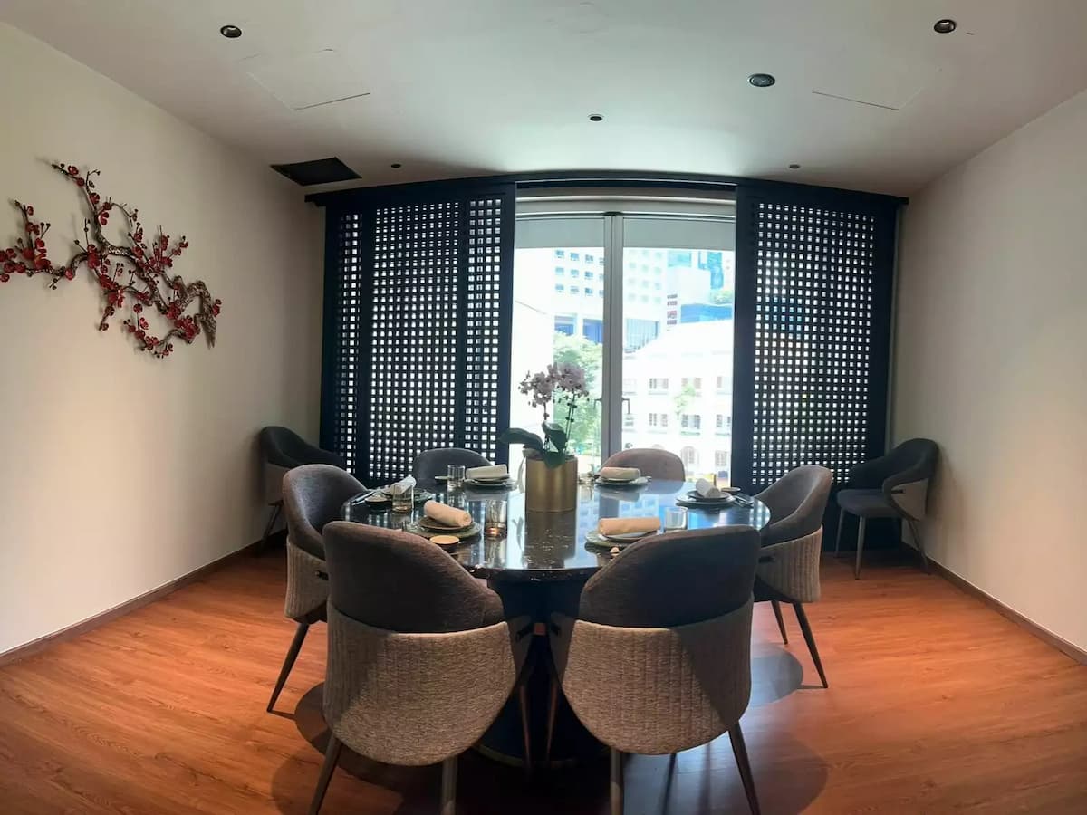 An elegant private dining room featuring a round black marble table set for six