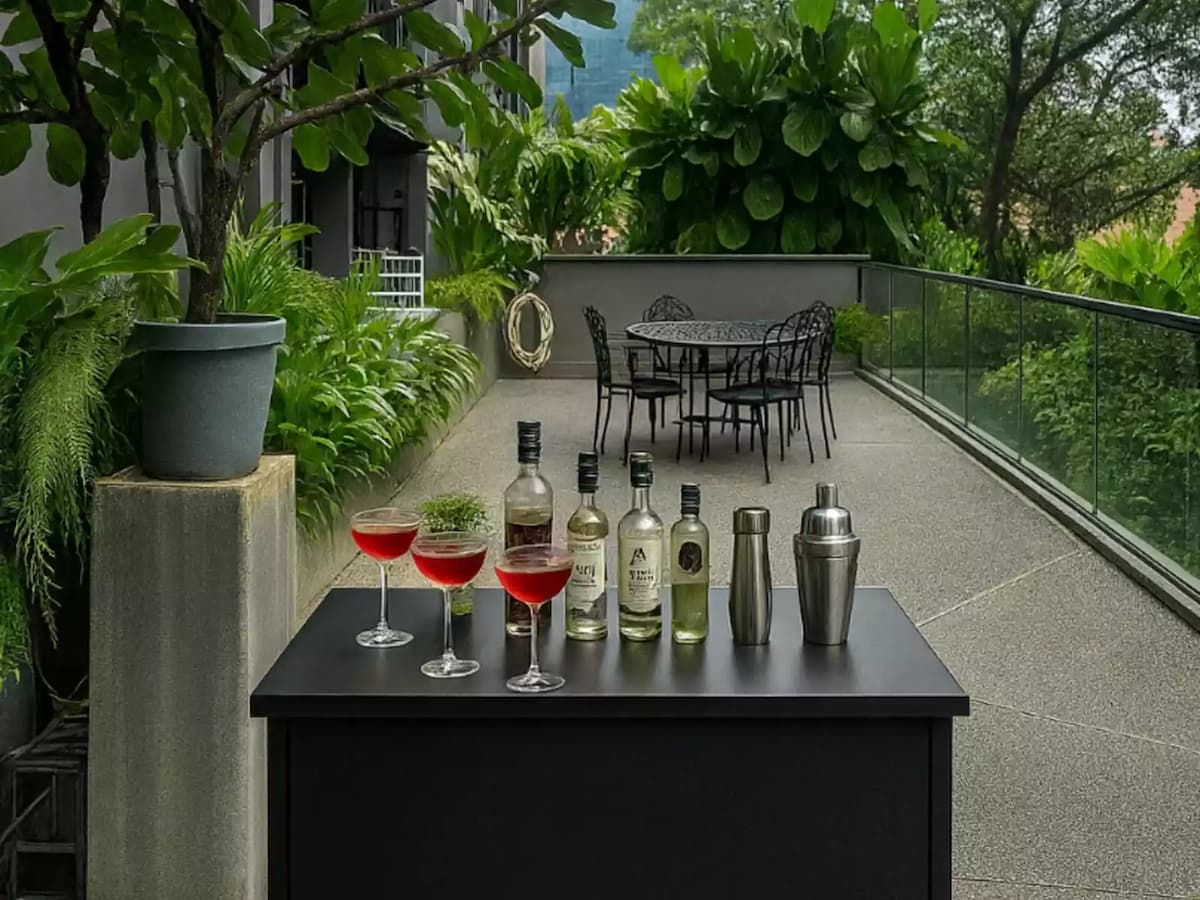 Outdoor terrace bar setup with cocktails and greenery