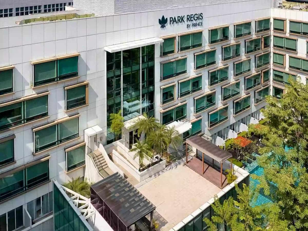 Park Regis hotel exterior with terrace and pool views.