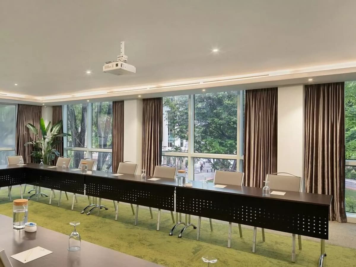 Conference room with long tables, projector, and window views.