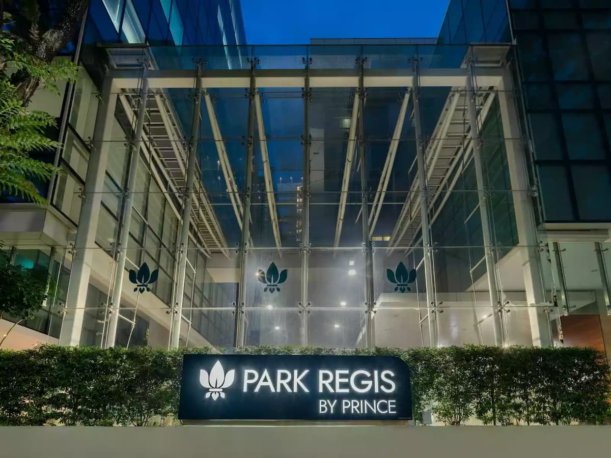 Park Regis by Prince glass façade illuminated at night.