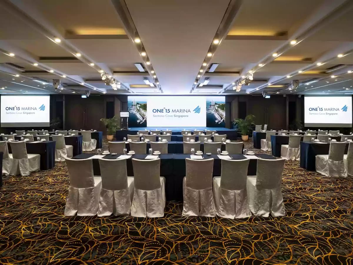Conference setup with classroom seating and presentation screens