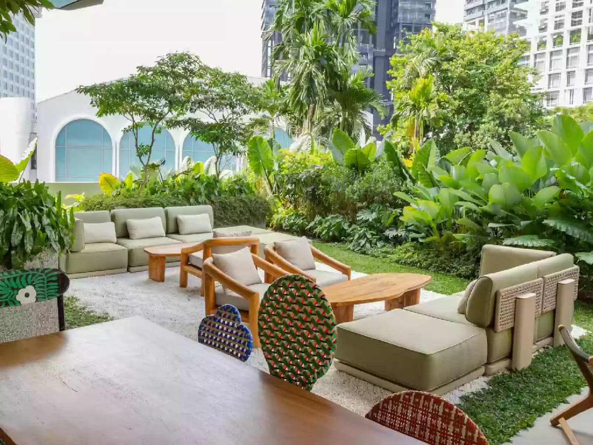 Outdoor garden event space with lounge seating at The Standard Singapore
