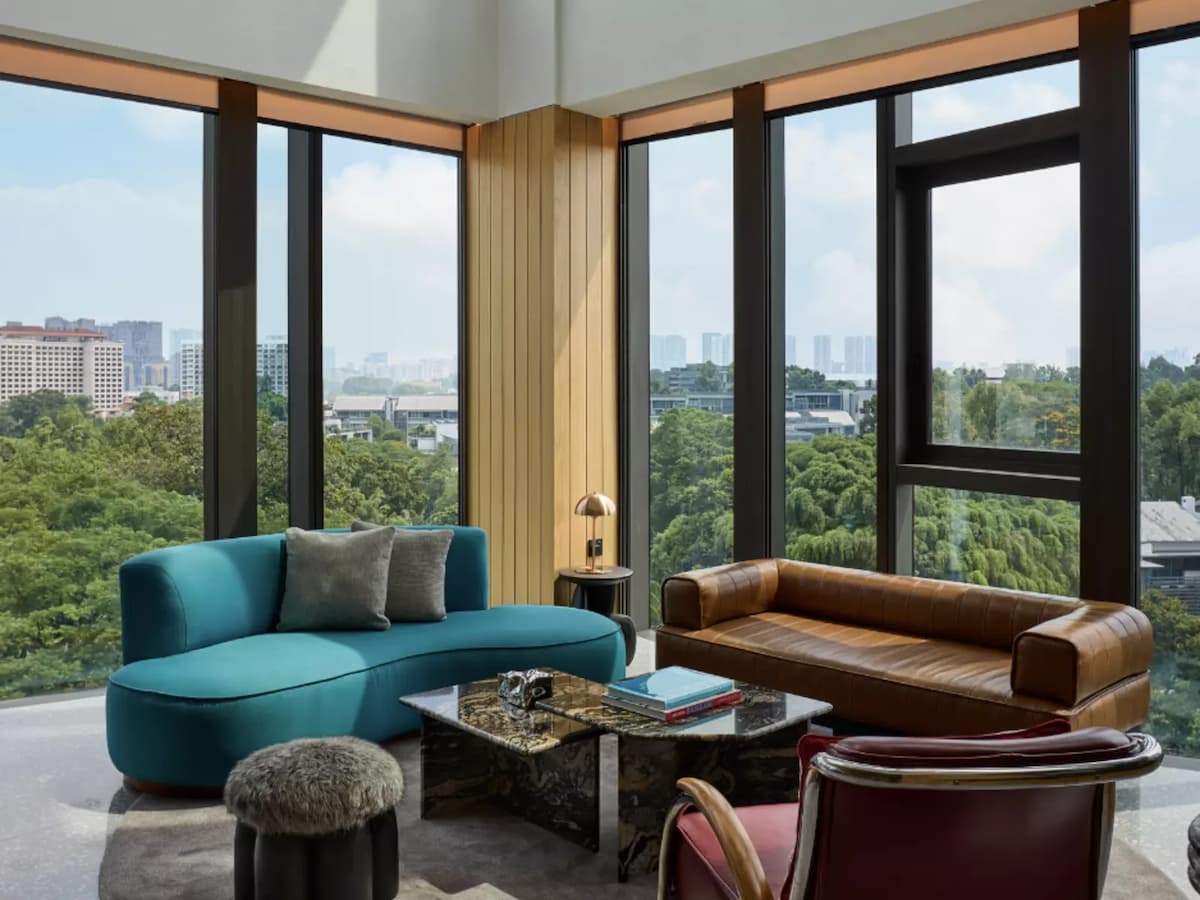 Suite lounge with city and greenery views at The Standard Singapore