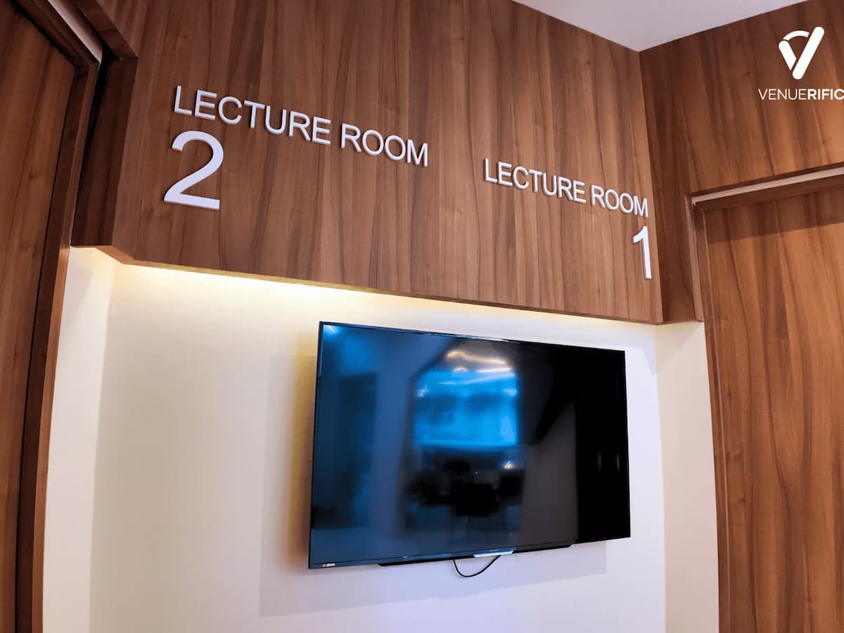 Mutiara Event Space lecture room signage with wall-mounted display screens