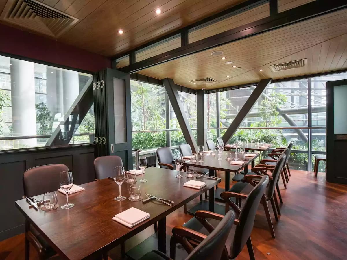 glass wall restaurant in singapore with foldable doors and wooden interior